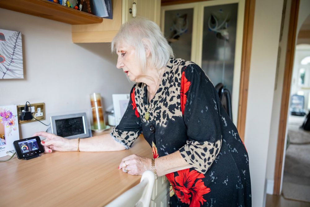 Woman adjusting smart meter