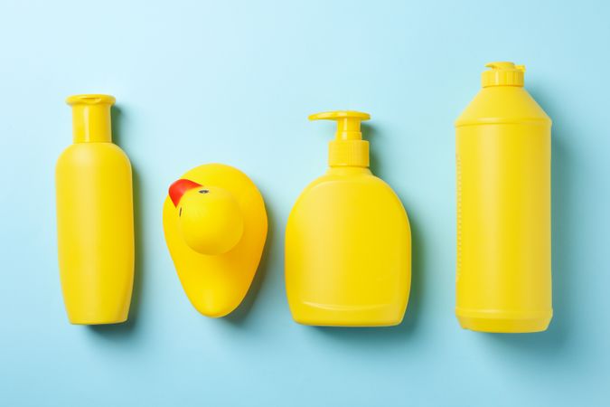 Flat lay with baby hygiene accessories on blue background