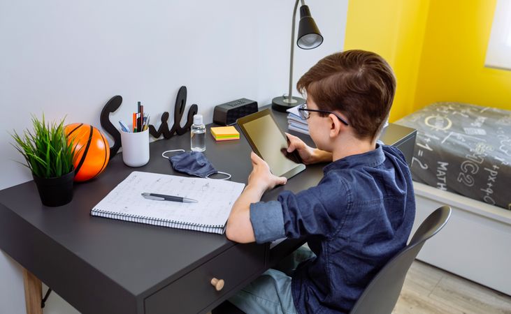 Teenager doing homework with a tablet