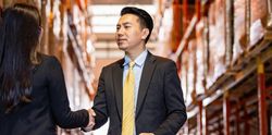 Banner of Asian professional male shaking hands of female colleague