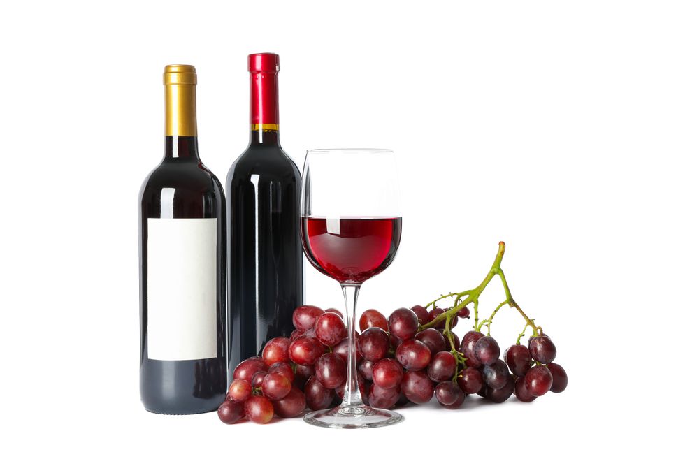 Grapes, bottles and glass with wine isolated on plain background