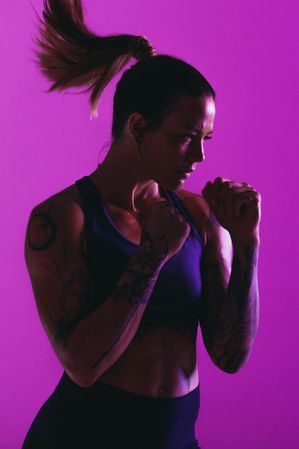 Female boxing trainer in fighting pose