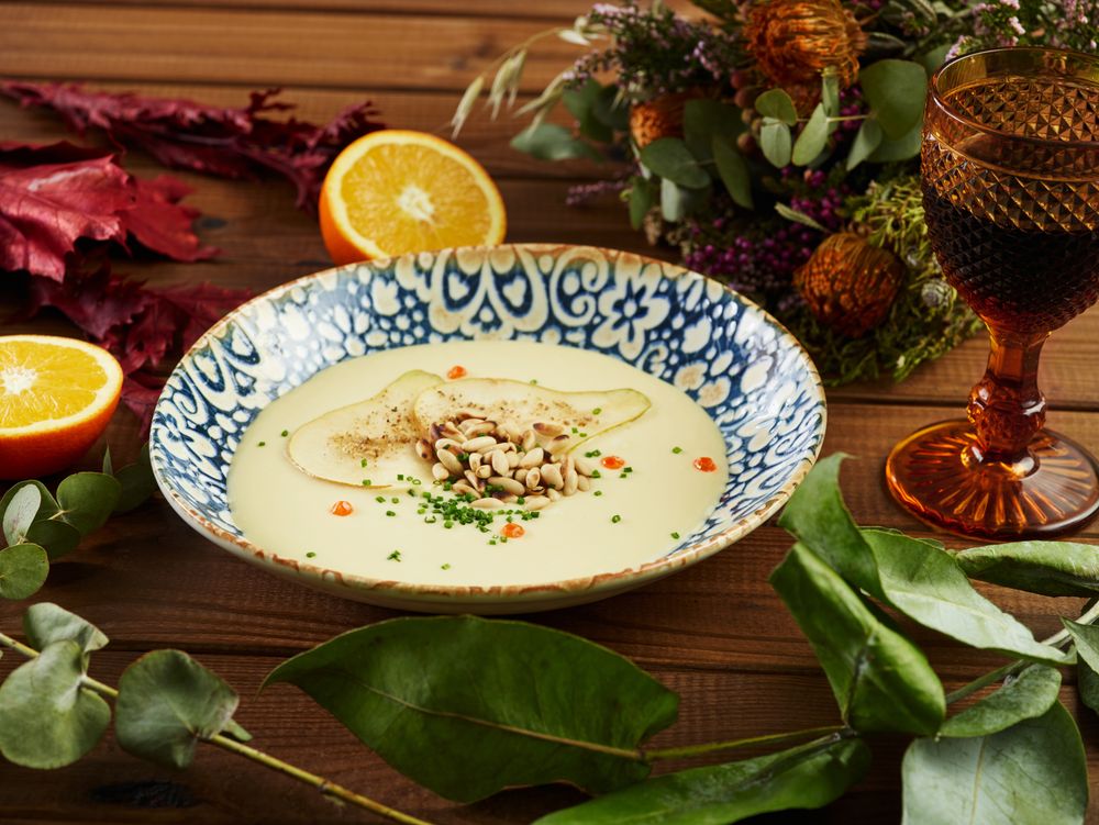Citruses and wine cream soup amidst floral twigs