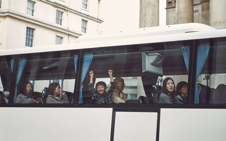 London, England, United Kingdom - March 23rd, 2019: Group of people looking out the window of a bus