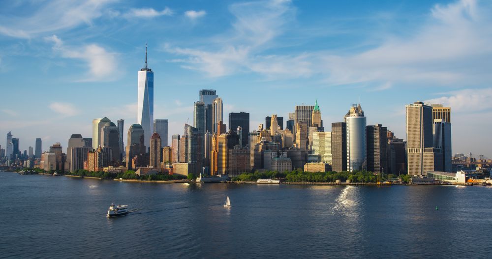 Panorama Around the Wall Street Financial District in New York City, USA. Aerial Shot with Office Buildings and Skyscrapers on a Summer Sunny Day with Blue Sky and Light Clouds