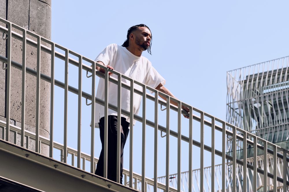Black male standing on bridge