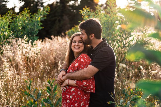 Young happy couple embracing in beautiful garden