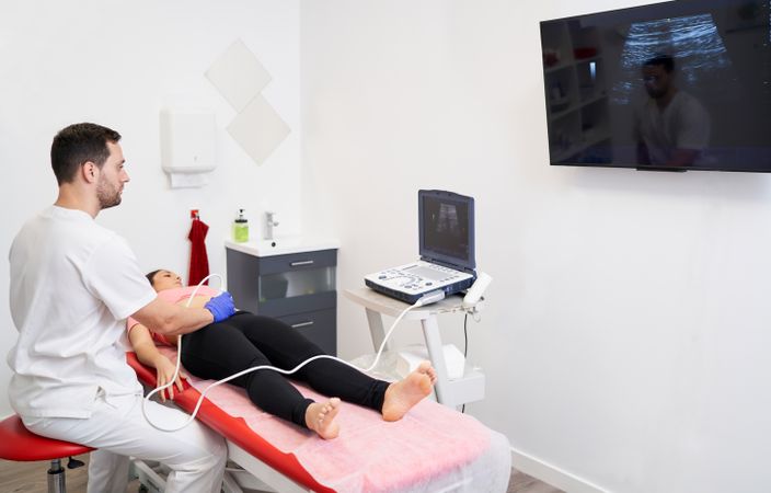 a physiotherapist performing an ultrasound scan for pelvic floor