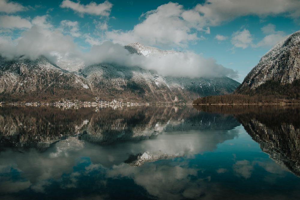 Perfect turquoise lake reflecting cloudy sky