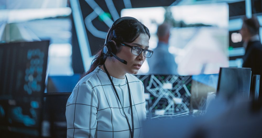 Portrait of a Female Fleet Operator Working in an Office Hub for Order Delivery, Control and Client Support.