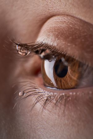 Anonymous kid with tears on eyelashes