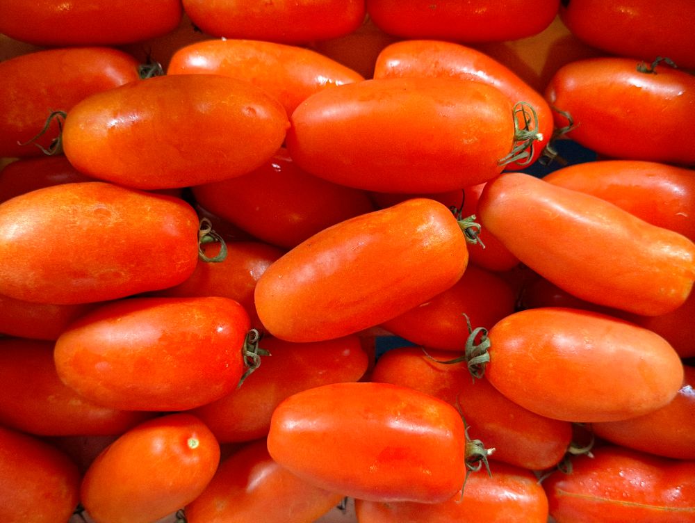 Long red heirloom tomatoes arranged for sale
