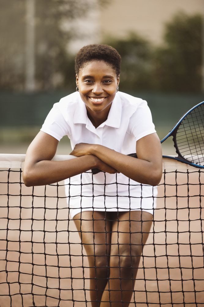 Young women with a racket in a tennis court
