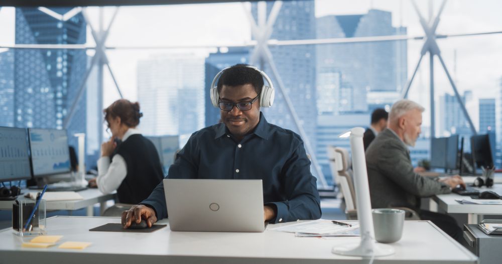 Professional Male Product Manager Working On a New Project In Diverse Workspace.