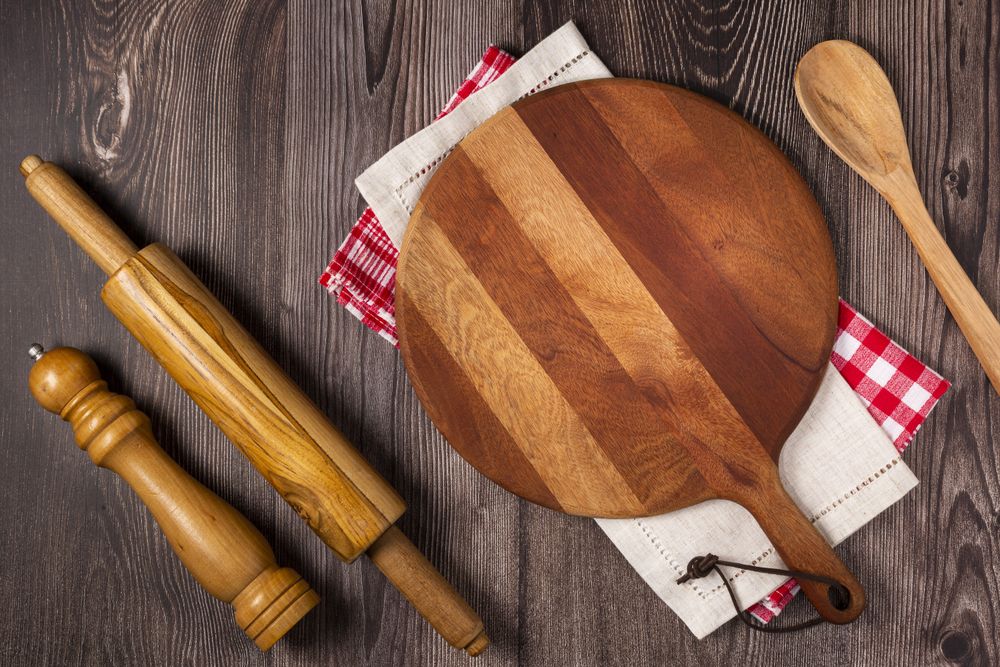 Empty pizza board on rustic wooden table. Top view image.