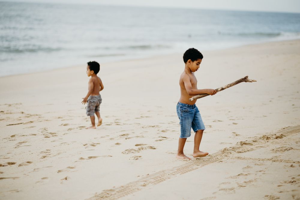 Black boys playing on beach