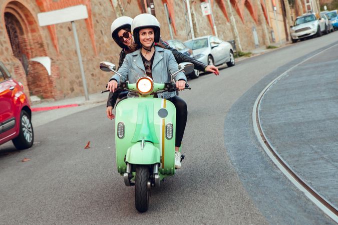 Young people riding motorcycles on city road