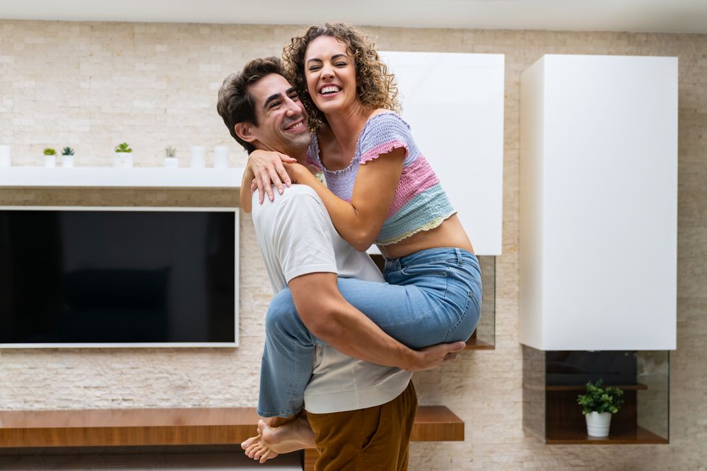 Affectionate couple holding each other in living room