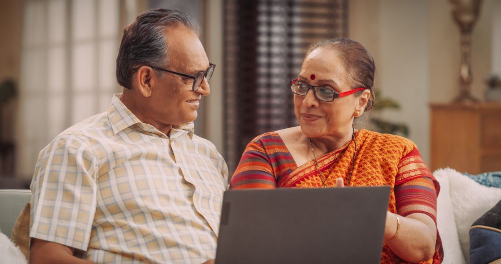 Indian Couple Use Laptop at Home