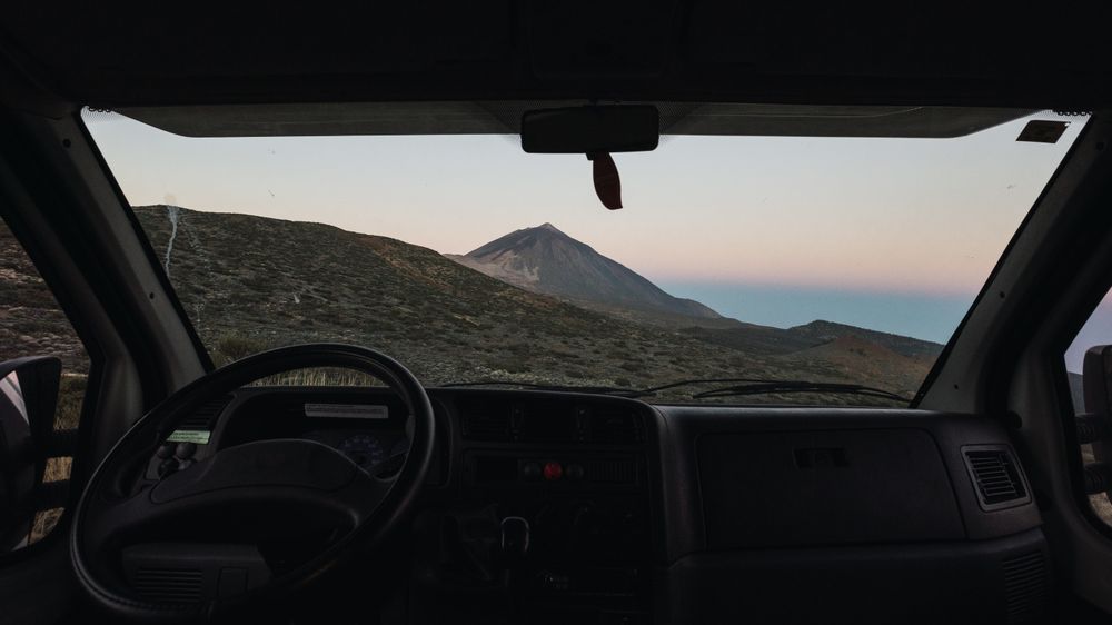View of mountain through window of car