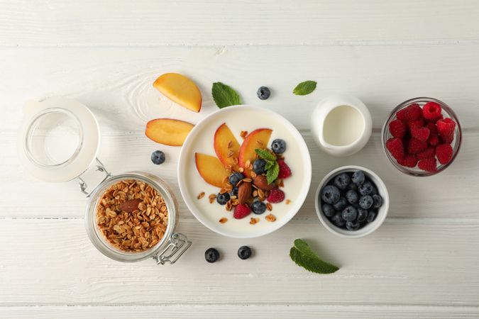 Flat lay composition with parfaits dessert and ingredients on wooden background