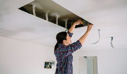 Woman preparing extractor hood installation
