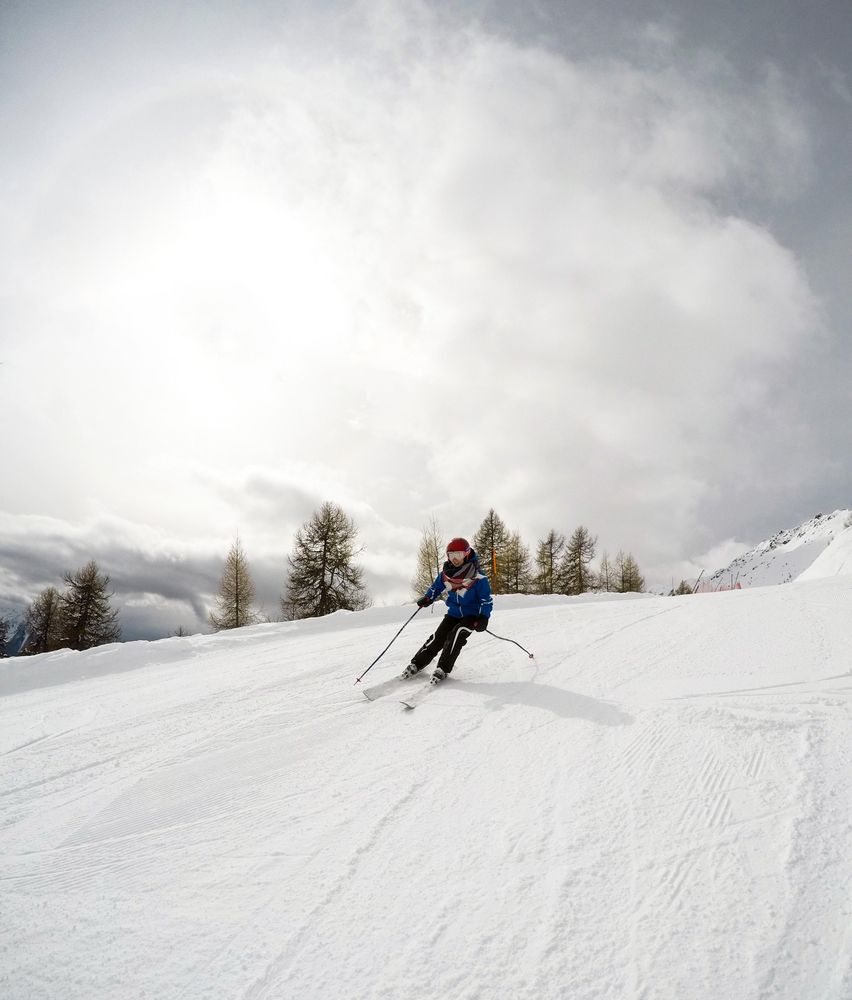 Person riding ski blades on snow covered ground
