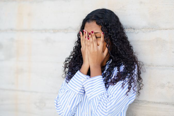 Emotional Moment A Young Woman Hides Her Face in a Moment of Deep Disappointment and Sadness