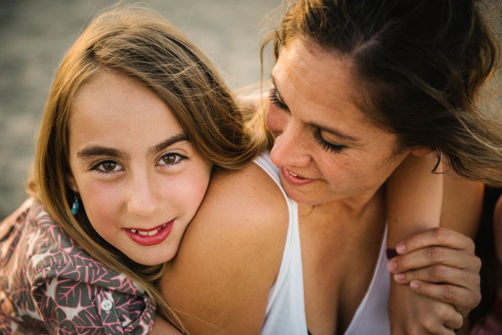 Woman with daughter on sunny beach
