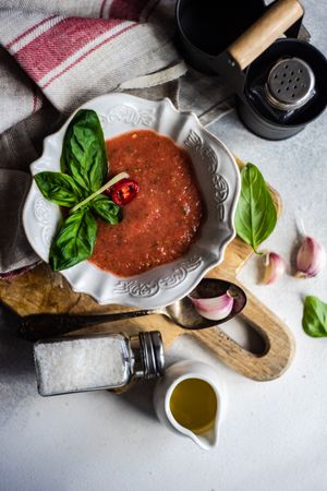 Cup of traditional gazpacho soup with basil, garlic and pepper