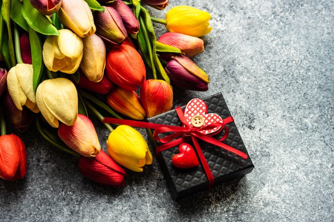 Top view of counter with tulip bouquet with present