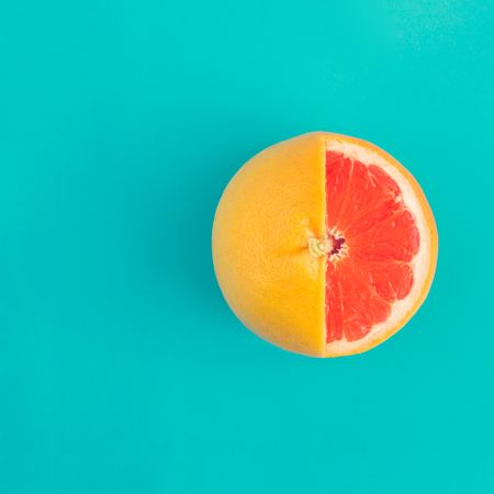 Grapefruit sliced on bright blue background