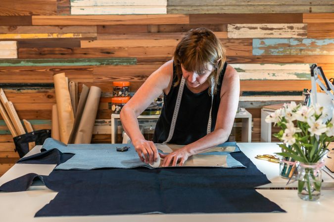 Fashion designer outlining fashion patterns with a tailor's chalk