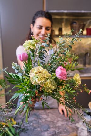 Female florist demonstrating bouquet
