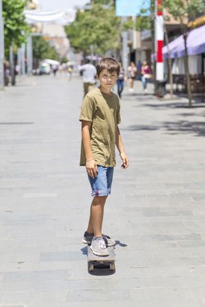 Teenage boy on a skateboard on sunny day