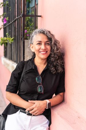 Mature woman in convinced attitude crossing arms