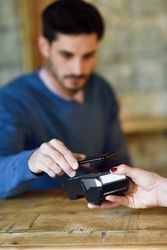Man paying woman with smartphone