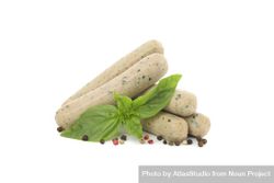 Light colored sausages on blank background with herbs 43WAR4