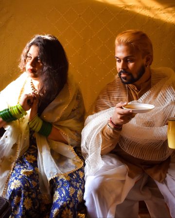 Indian man and woman sitting indoor