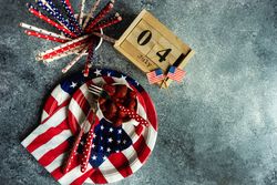 Independence Day celebration table setting on grey counter with strawberries with copy space