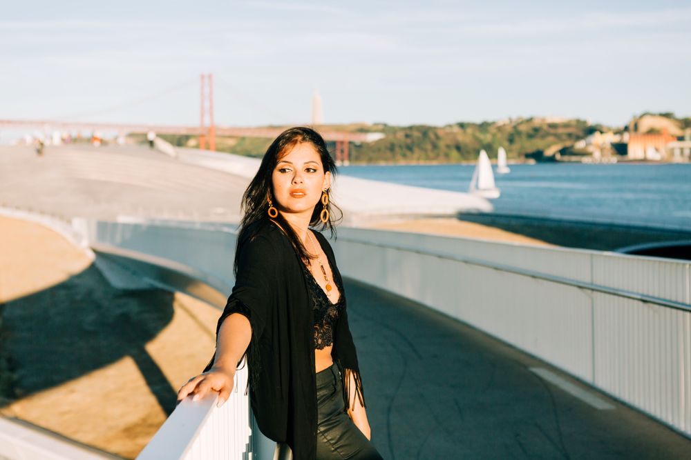 Trendy female standing on urban background