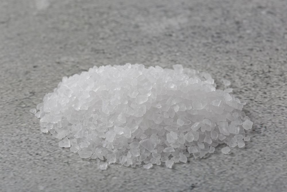 Handful of coarse salt on the table.