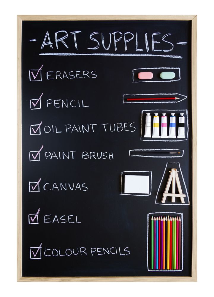 Art supplies over chalkboard background