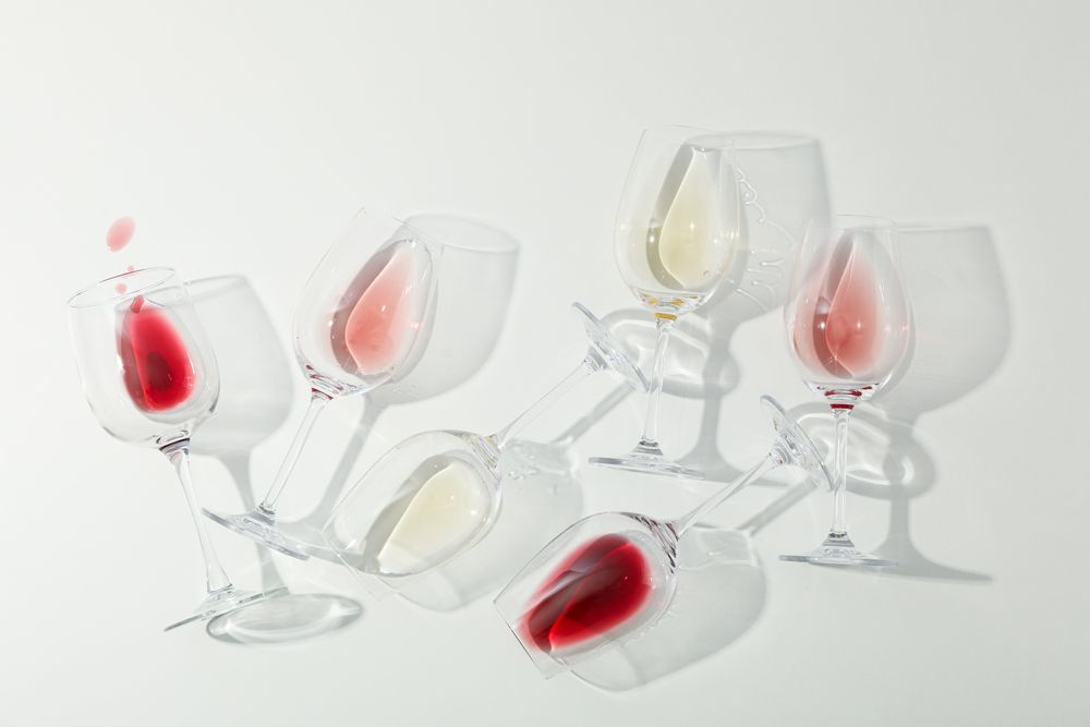 Flat lay composition. Glasses with different wine on blank background