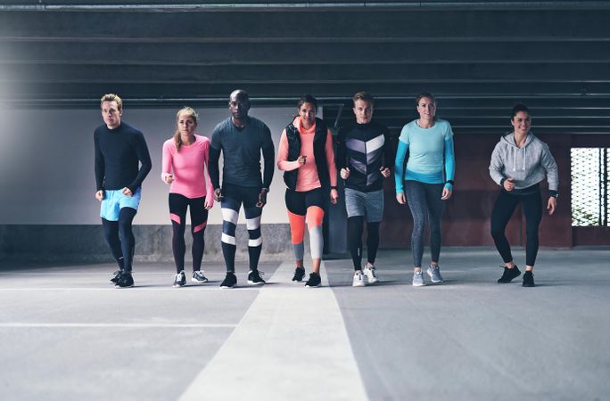 Multi-ethnic group of people standing last starting line before run