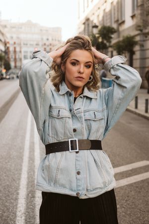 Stylish woman in middle of city road