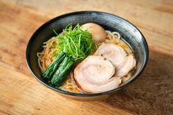 Appetizing Asian soup with noodles chashu and nori in bowl
