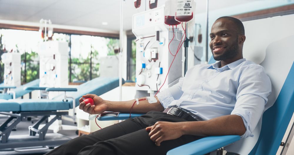 Black Businessman Donating Blood For People In Need In Bright Hospital.