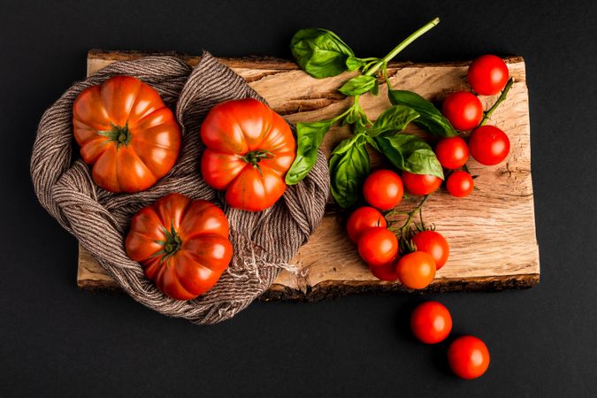 Tomatoes and napkin on wooden board
