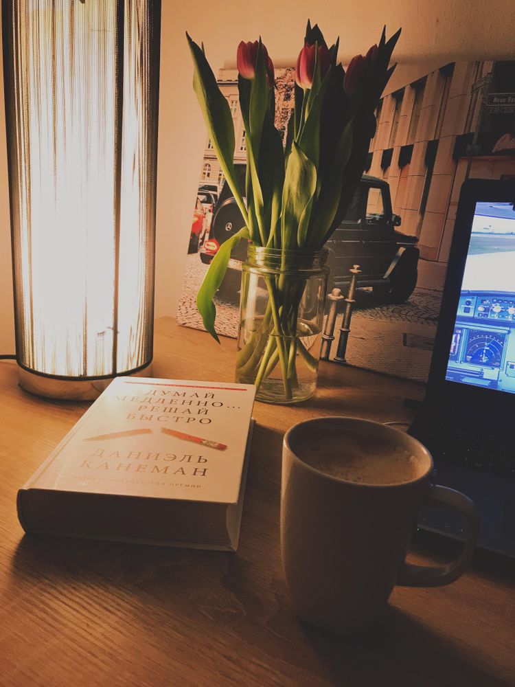 Book beside mug and computer on a desk